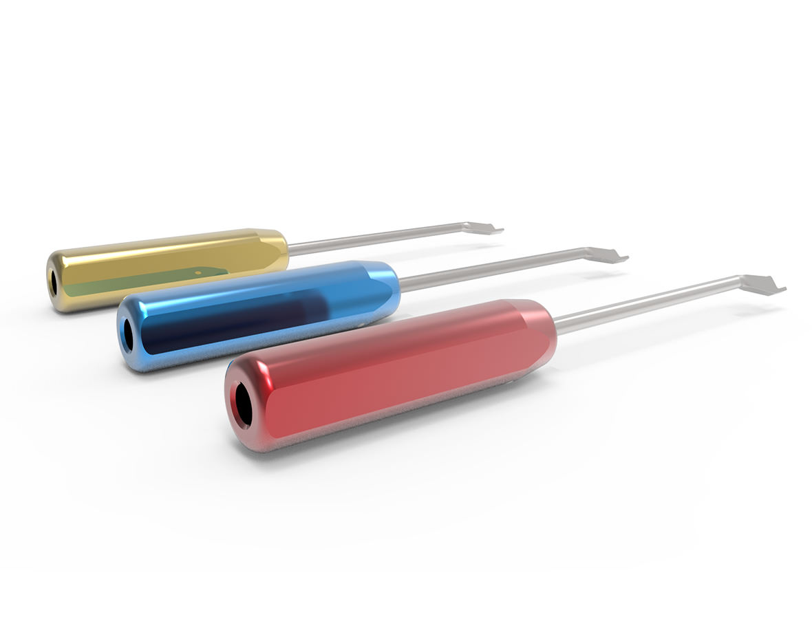 Yellow, blue and red femoral guides next to each other on a white table