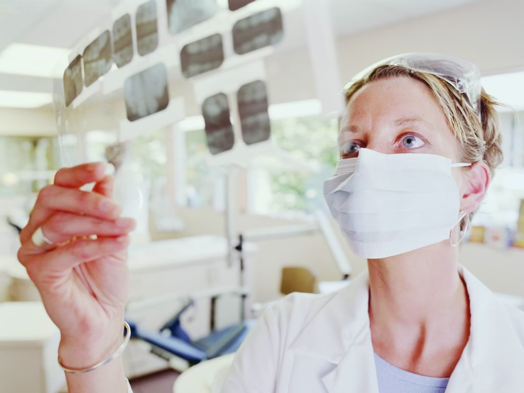 Surgeon looking at X-ray images.